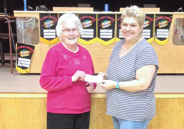 The Kinsella Satellite Bingo winner was Esther             Johannesson of Hardisty. She won $2,341 this month. On the left, a smiling Esther accepts her winnings from Kinsella Bingo Committee member Michelle Armitage.