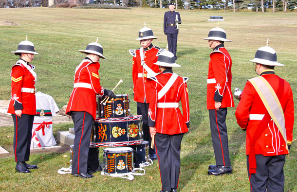 The stacking of the drums started a Grave Marker rededication ceremony, for WWI veteran VC Cecil Kinross, held Saturday, Oct. 24 at the Lougheed Cemetery, by the Loyal Edmonton Regiment (#4 PPCLI). The                hour-long ceremony was held to unveil a new grave marker to indicate that Kinross was a Victoria Cross recipient for his bravery during the Battle of Passchendaele. The bugler, standing at attention in the above photo, wore a uniform identical to that which Kinross would have worn during his time in the service. 