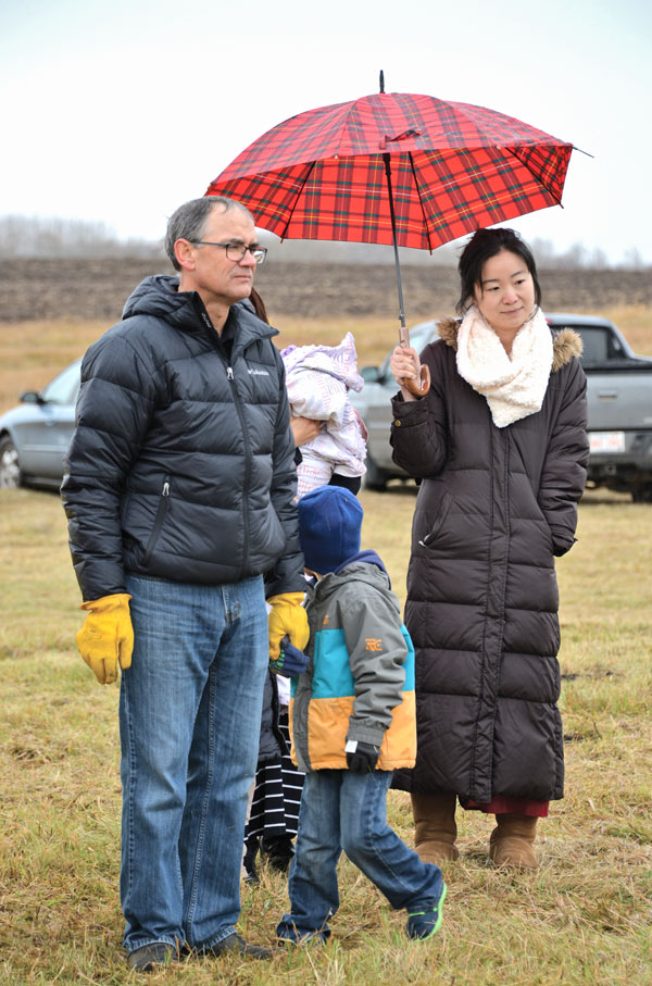 Brian Rozmahel and Dr. Cecilia Wu, the Assistant Chief Medical Examiner, take part in the touching ceremony which saw the human remains found August 26 laid to rest in a specially selected location on the Rozmahel farm. Photos supplied by Communications Branch, Alberta Culture and Tourism