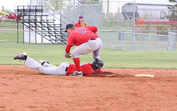 Second baseman Trent Steil makes the pick on a Castor base runner.