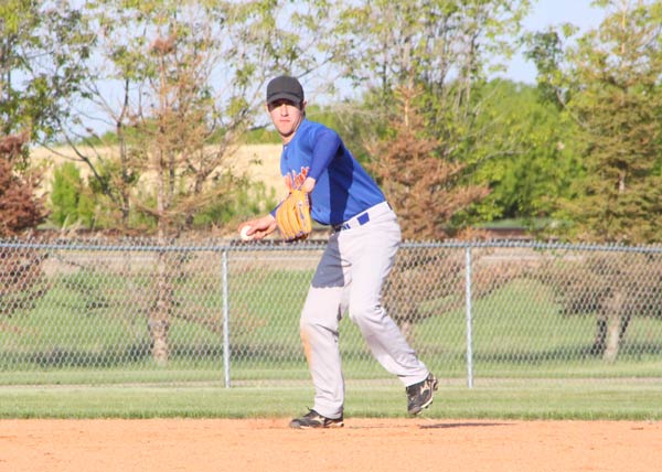 Justin Ness of the Lougheed Wildcats makes the throw to first base, 