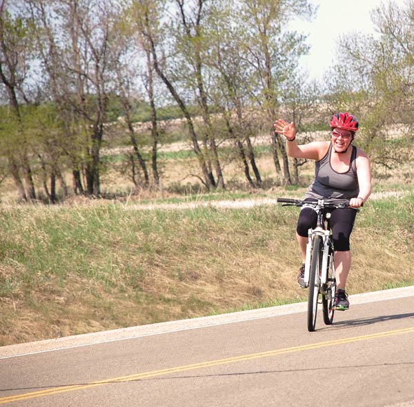 Participants had a wave and smile for the camera during the bike portion of Saturday's Tri-it Triathlon