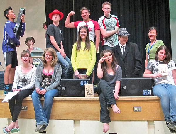 Some of the cast of the AJS Production of ‘Lucky Lucky Hudson and the 12th Street Gang’ take a break, with director Brenda DeKock. Note the two new on-stage monitors, purchased with funding from the Battle River Community Foundation grants, as well as head sets with microphones.