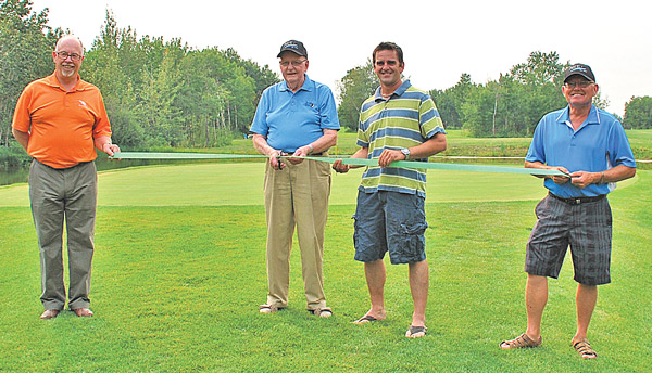 On Aug. 14, the new island green on the third hole of the Daysland Golf Course was officially opened, with course founder Bob Hanrahan doing the honours of cutting the ribbon. The project has been in the works for seven years, and was opened for play last month. From left: Doug Rowland, Vice President of the course, Bob Hanrahan, Mike Mickla of Daysland Backhoe, and Gerry Blatz, Club Grounds Superintendent.