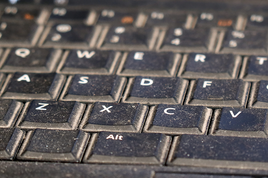 Dusty keyboard on a used laptop showing wear and tear during everyday tasks